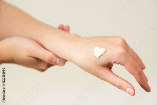 Young woman's hands with moisturizer. Moisturizing cream on a woman's hand