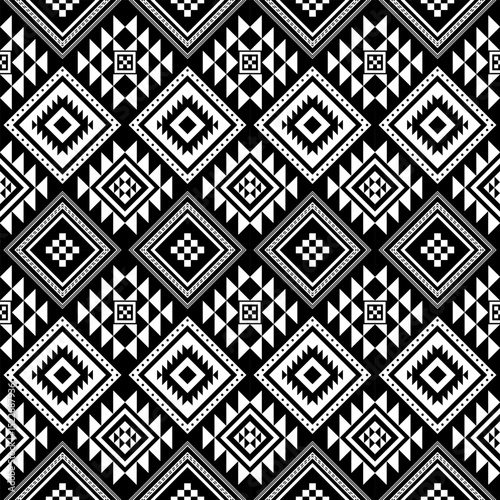 A bold black and white seamless pattern with Aztec tribal diamond and triangle motifs. Ideal for textiles, modern boho decor, digital backgrounds, and fashion design.