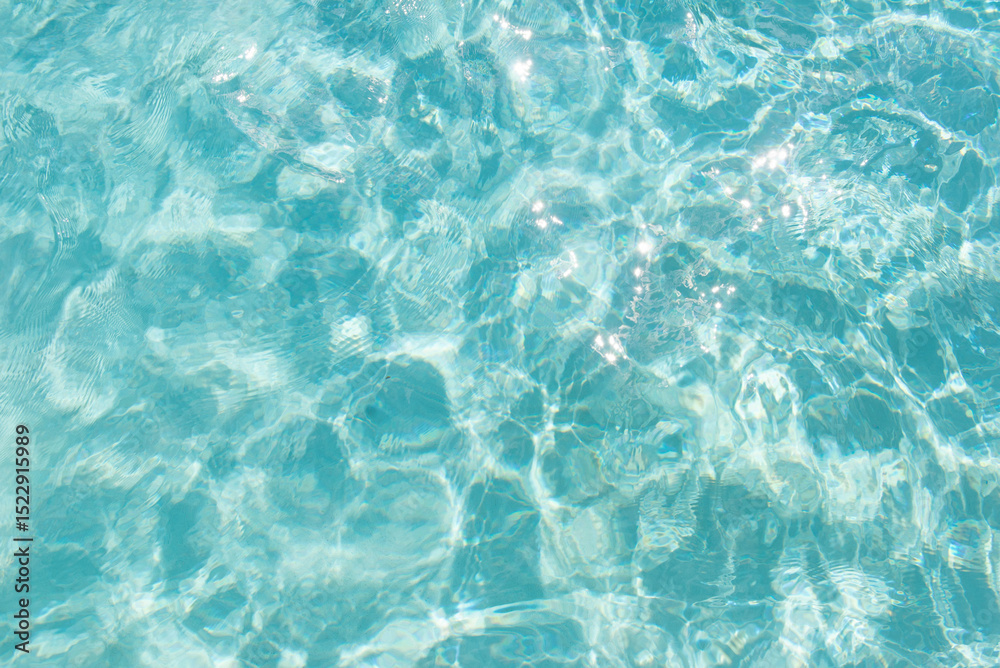 Obraz premium Blue water texture with sunlight sparkles and soft ripples