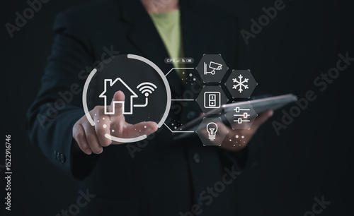 Person using a digital touchscreen to manage smart home devices including lights, security, and appliances. Ideal for IoT, home automation systems, and connected living technology.