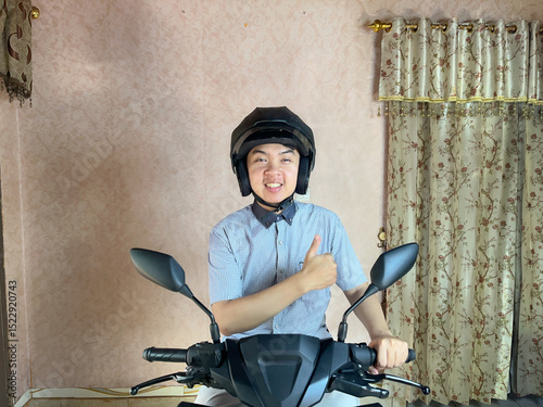 A man sitting on the motorcycle smiling and give thumbs up