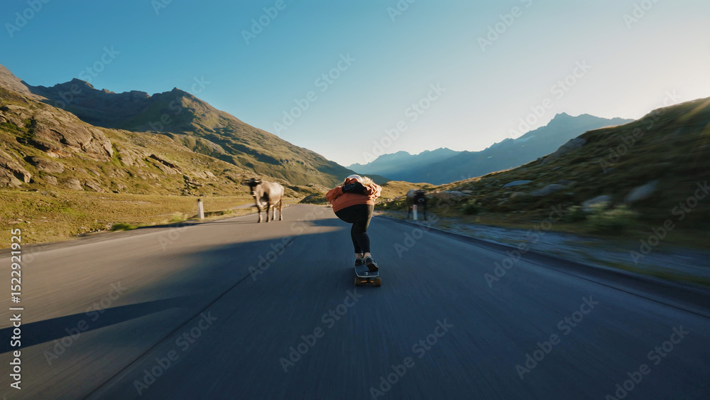 Fototapeta premium woman skateboarding and making tricks between the curves on a mountain pass.