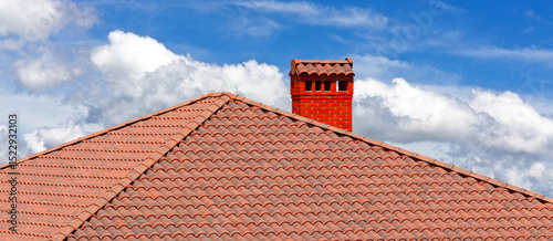 house with a roof from a red shingles with a pipe