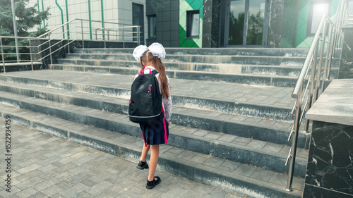the child goes to school. the girl in the morning, goes to school. portrait of a happy child with a briefcase on his back. concept student goes to school.