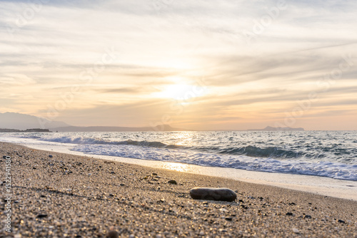 Fototapeta Naklejka Na Ścianę i Meble -  Beautiful coastline with a sandy and pebble beach at sunset. Beautiful sky coloration in the tourist and hotel area of ​​Platanes Beach, Rethymno, Crete, Greece