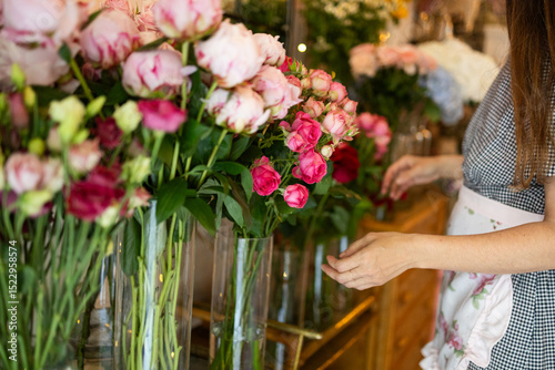 Woman arranging flowers in a charming flower shop