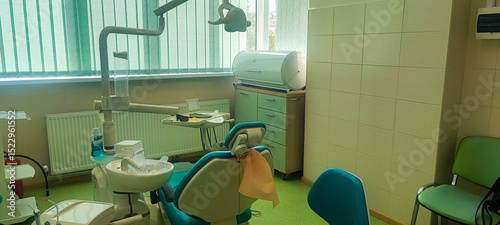 Modern dental clinic, dental chair and other accessories used by dentists. Concept of pediatric dentistry, treatment of oral diseases.