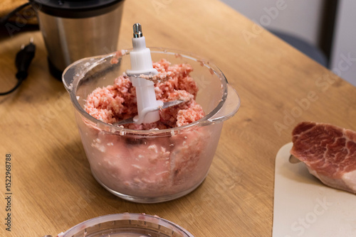 Just ground meat mince in the glass bawl of the electrical chopper on the kitchen counter top. Cooking