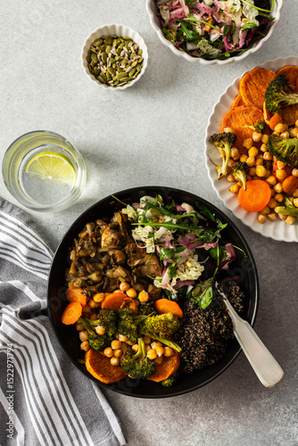 A balanced breakfast bowl with black quinoa, avocado, roast chicken, and sweet potatoes, topped with a fresh cabbage and radish salad