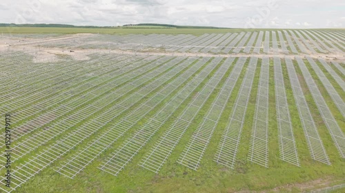 4K Drone footage of a construction site for a photovoltaic park, solar racks for solar panels and modules.