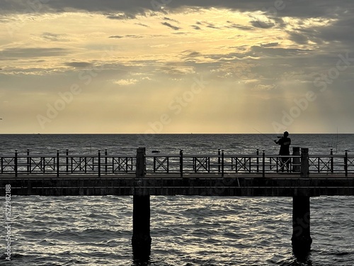 sunset on the pier, fisherman,Bang Saen, Chonburi, Thailand