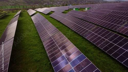 Rows of solar panels capture sunlight in field at sunset photo