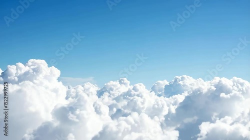 Expansive view of billowing white clouds against a clear bright blue sky creating a serene atmosphere ideal for calming backgrounds.