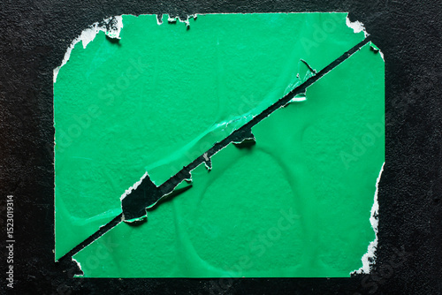 Old green poster with folds.