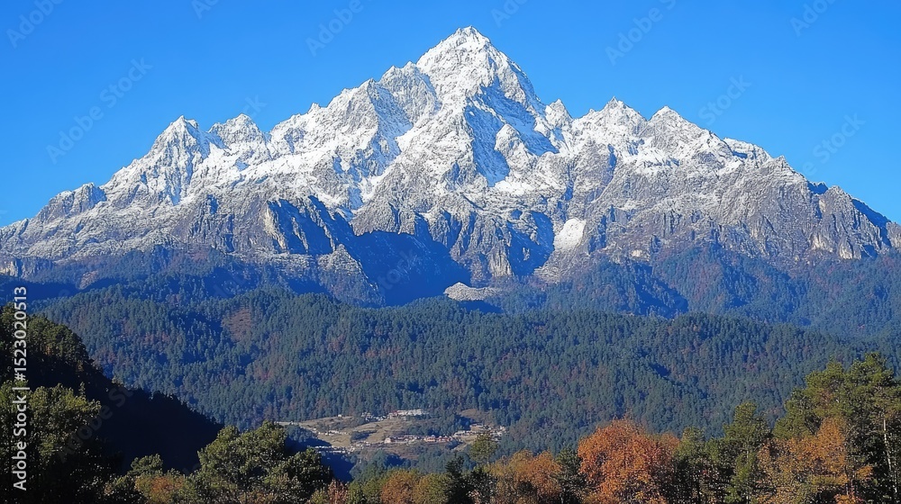 Fototapeta premium Snow-capped mountain range against a clear sky.