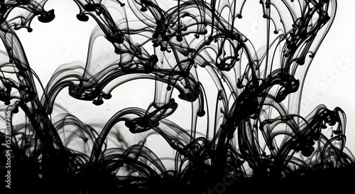 Abstract Black Ink Trails Flowing Through Clear Liquid Backdrop