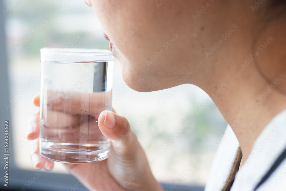 A woman drinking a glass of clean water. Promotes healthy lifestyle, hydration, wellness, and self-care. Ideal for health, nutrition, and lifestyle content. A woman drinking a glass of clean water. Promotes healthy lifestyle, hydration, wellness, and self-care. Ideal for health, nutrition, and lifestyle content.