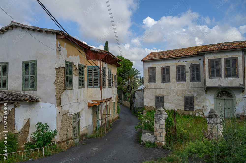 Fototapeta premium Old stone houses on a narrow street in Lefke, capturing the authentic charm of Cypriot heritage.