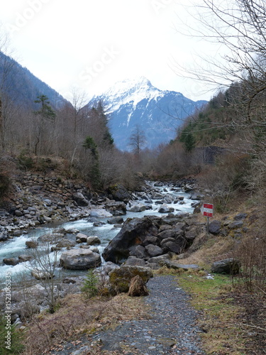The Lütschine River with the Swiss Alps in the background. Lauterbrunnen, Switzerland - February 12, 2025. 