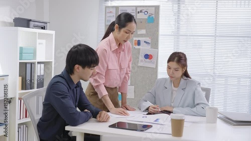 diverse team of business professionals actively engages in a strategic meeting focused on financial planning, goal alignment, and agile execution. With open laptops, financial reports graph chart