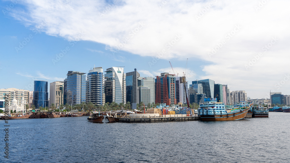 Buildings and traditional wooden boats on Dubai Creek, United Arab Emirates Buildings and traditional wooden boats on Dubai Creek, United Arab Emirates