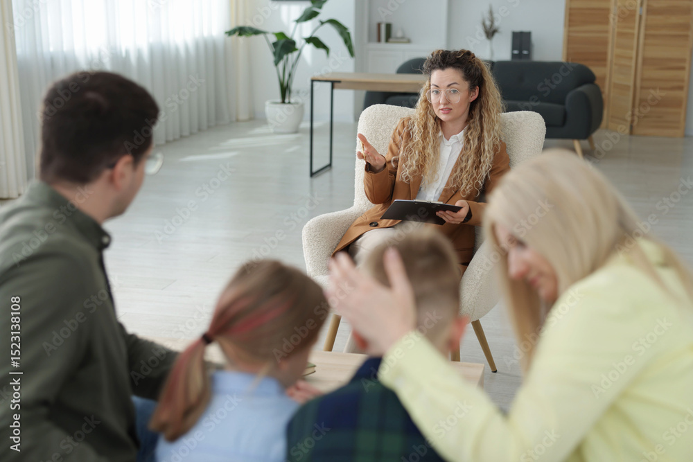 Fototapeta premium Family having consultation with psychologist in office, selective focus