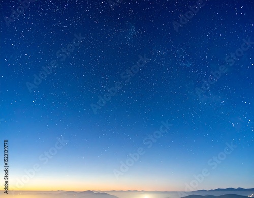 Starry night sky over a misty horizon