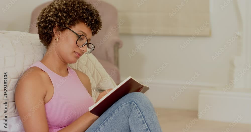 Flipping notebook pages, woman in pink top and jeans scribbling journal entries with pen beside bed