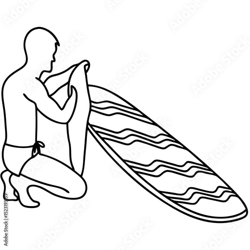 Man cleaning surfboard after surfing session.  Surfer carefully wipes his surfboard with a towel, preparing it for storage.