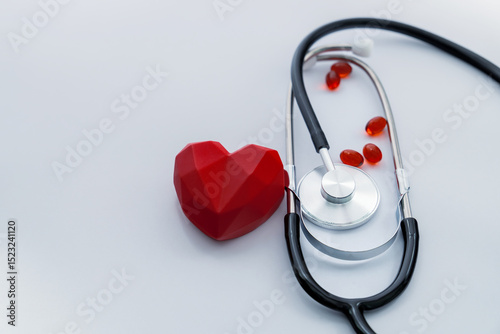 Stethoscope with red heart and pills symbolizing online medical consultation and healthcare support