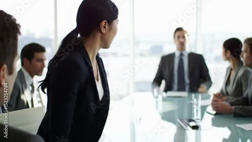 Woman showing frustration during a business meeting in a modern office setting