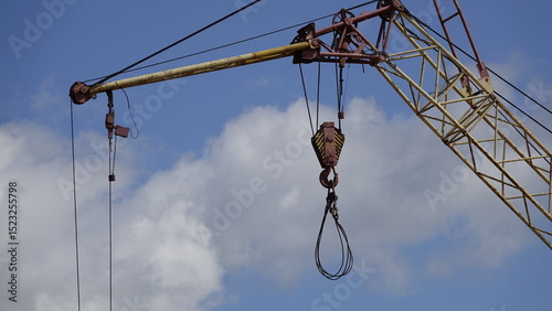 Fotografie “Spider” is a construction site crane hitch with four metal hooks for moving loa