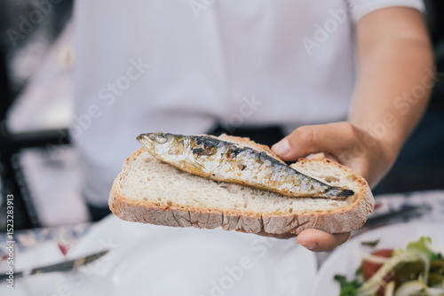 Wallpaper Mural A grilled sardine on a slice of bread - traditional meal during the Saint Anthony festival  Torontodigital.ca