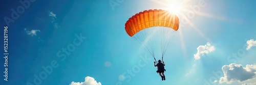 Breathtaking aerial view of a skydiver gracefully falling against a vibrant blue sky, sunlight illuminating the parachute A stunning display of freedom and adventure , sunlight, sky