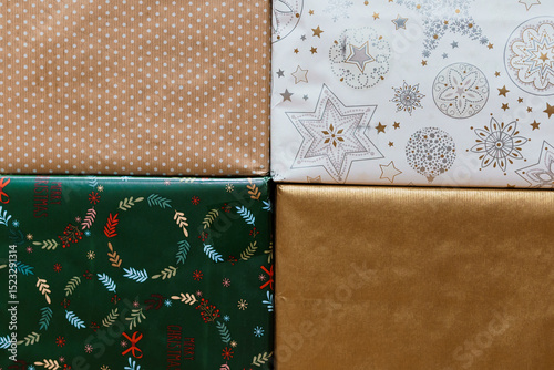 Bild auf Leinwand Assorted Christmas Wrapping Papers Stacked on Dark Surface, Festive Holiday Deco