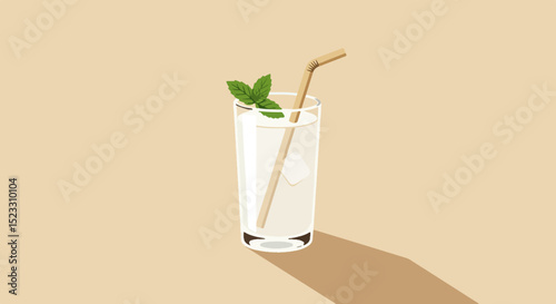 Tall clear glass with mint leaves and bamboo straw on light beige background