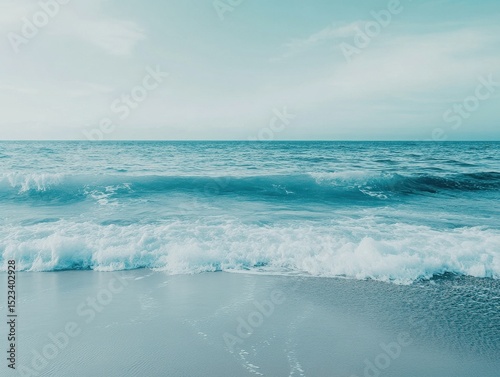 Serene ocean waves gently crashing on sandy beach shore