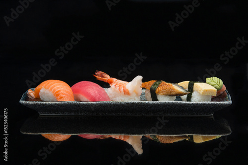 salmon, tuna, ebi, prawn, eel, tamago, nigiri sushi on a plate 