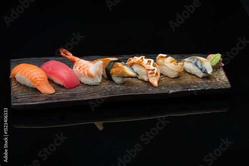 salmon, tuna, eel, aburi salmon, aburi scallop, kingfish, nigiri sushi on a plate 