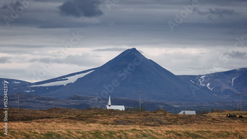 Tall church in the middle of scenic landscape at small village Borgarnes, Iceland .
