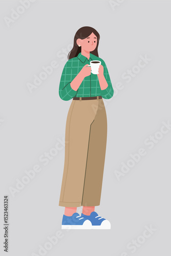 Woman holding a cup of coffee wearing green shirt beige pants and blue shoes