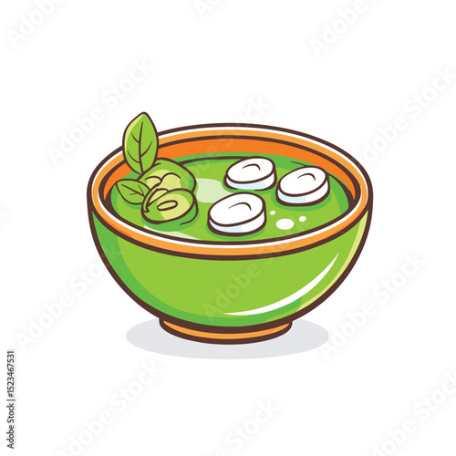 Green soup in bowl with leaves and topping
