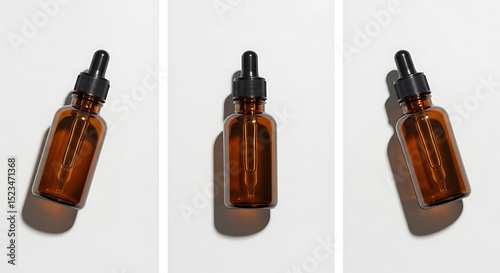 Three amber glass dropper bottles on a light background.