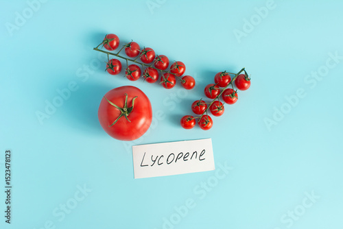 Red tomatoes and cherry tomatoes in close-up on a pink background the inscription lycopene as the main antioxidant in tomatoes