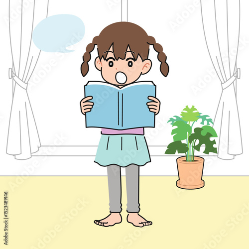 居間で教科書を音読する女の子