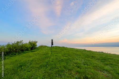 Принти на полотні Silent Observer: A lone figure silhouetted against a vast sunset sky over the serene Black Sea coast