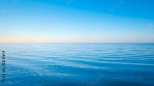 Wallpaper Mural Calm Blue Sea Under a Clear Sky with Gentle Waves Reflecting Natural Light Creating Serene Backdrop Torontodigital.ca