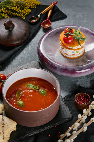 Vegan menu featuring gazpacho and pumpkin mille-feuille with tofu, dramatic lighting, vibrant color, editorial overhead composition