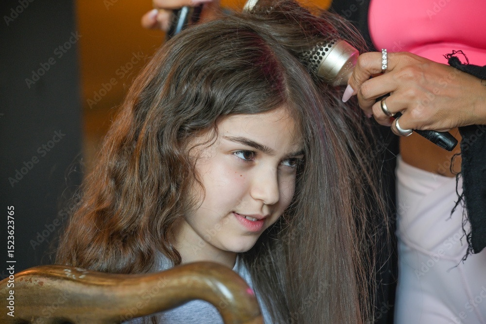 Fototapeta premium High resolution image of a single beautiful twelve year old Caucasian girl photo shot getting makeup and hair done