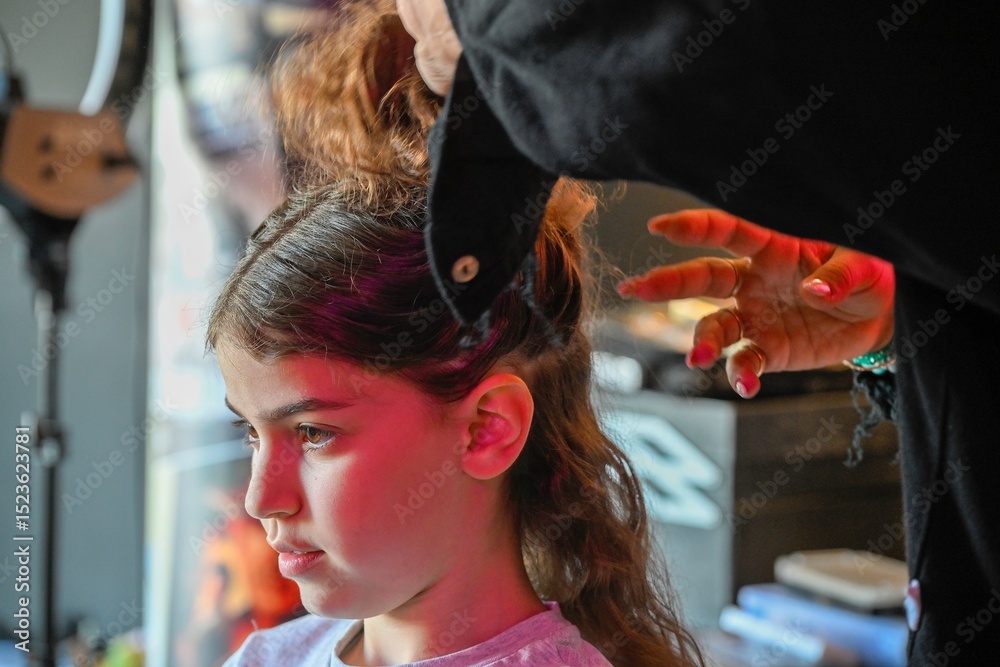 Fototapeta premium High resolution image of a single beautiful twelve year old Caucasian girl photo shot getting makeup and hair done